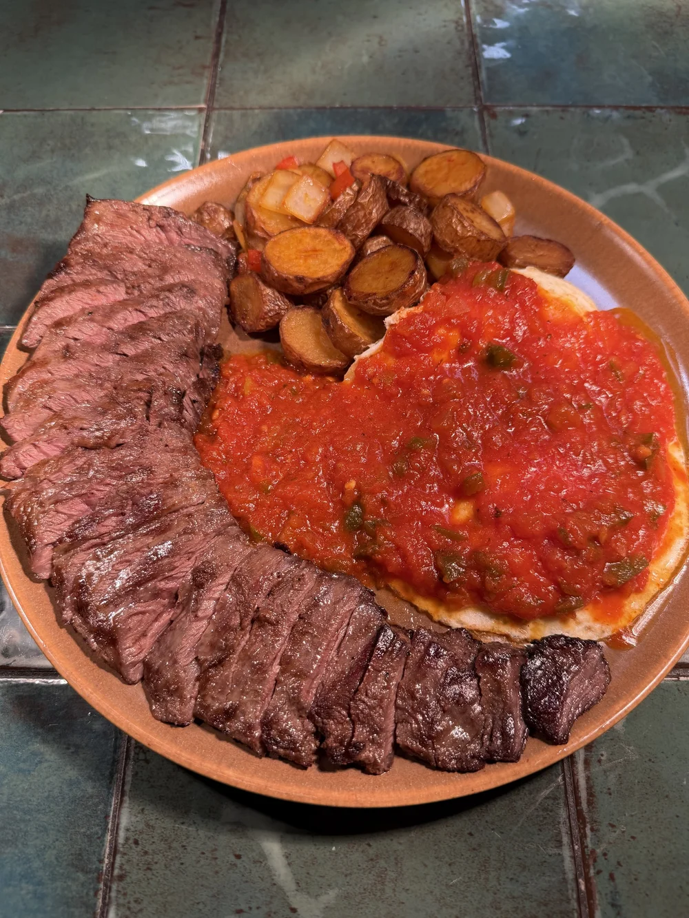 Char-grilled arrachera steak with salsa roja, guacamole, and blistered peppers
